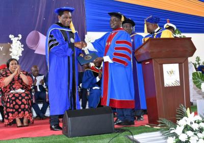 H. E. President of Zambia, Hakainde Hichilema (left), robed in an Honorary Doctoral Gown and receiving a certificate from the Chancellor of VVU, Pr. (Prof.) Robert Osei-Bonsu. 7-7-2023